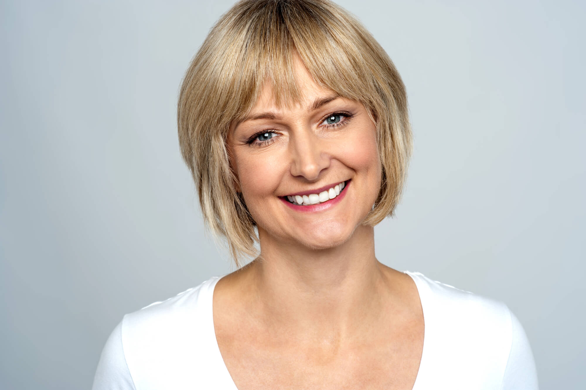 a smiling woman after seeing an expert in Cosmetic dentistry in midtown Manhattan 