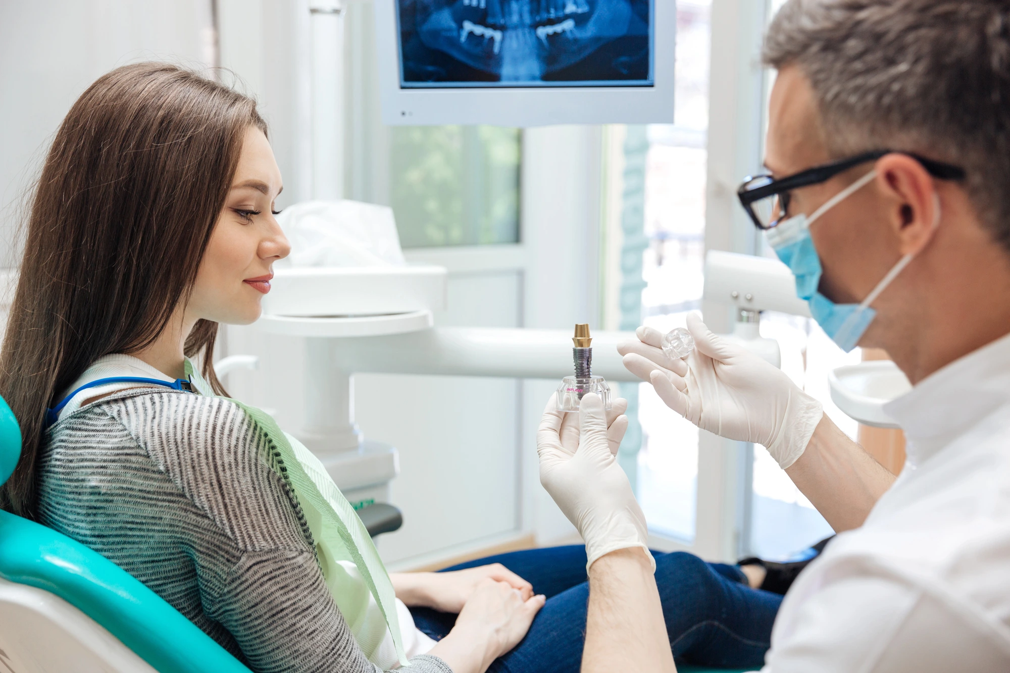 dentist explaining Same day Crowns in Murray Hill to patient