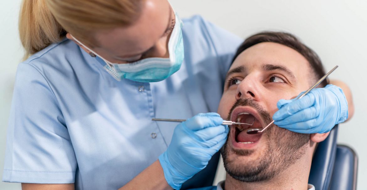 Dentist-Kips-Bay-performs-oral-examination-on-male-patient
