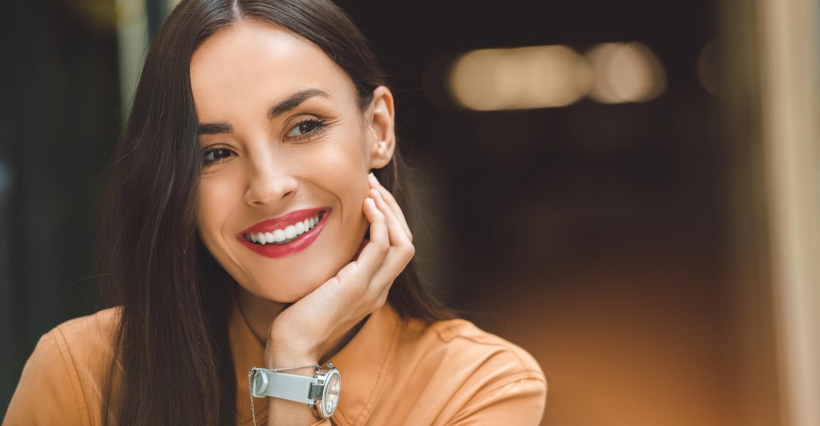 happy patient smiles at dentist in Murray Hill