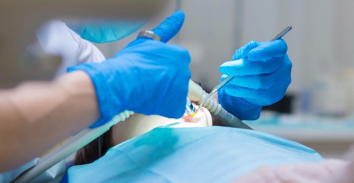 dentist performing procedure while patient is under Sedation Dentistry Murray Hill