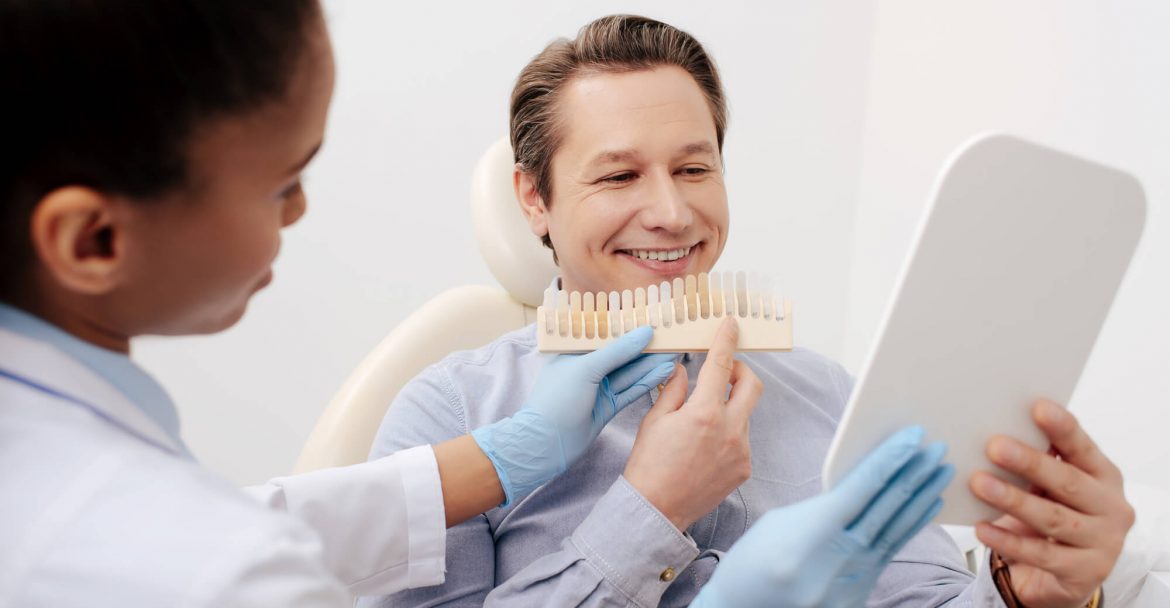 patient choosing a shade for his Cosmetic dentistry Murray Hill procedure
